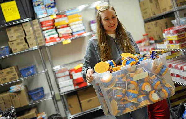 High-school student gathering food from pantry