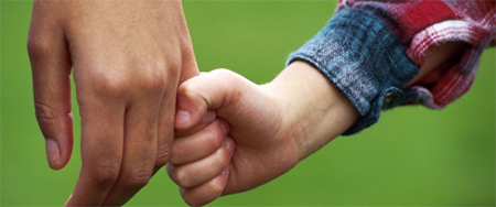 Child holding adult's pinky