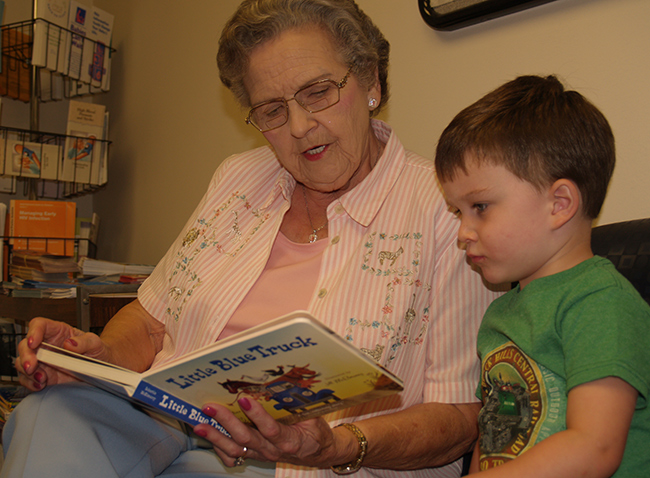 MandaLee Johns reads to a child in the Charlton County Health Dept.