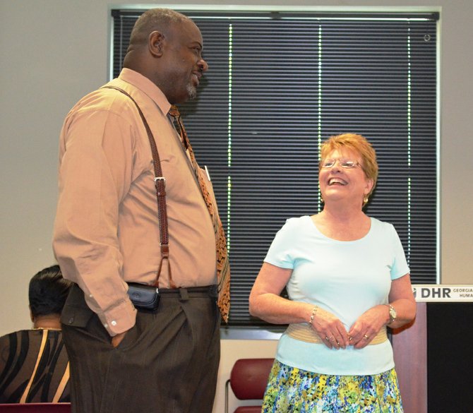 The Rev. Solomon Loud, left, of New Beginning Church, talks with Sandy Bamford, CEO of the Family Literacy Connection, Wednesday at a quarterly meeting of Albany area organizations that are working to improve literacy in the area. 