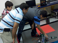 Three boys build a robot