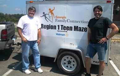 Catoosa Family Collaborative coordinator Phil Ledbetter (left) and David Fields, Catoosa Prevention Initiative administrative assistant, standing by the Region 1 Teen Maze trailer