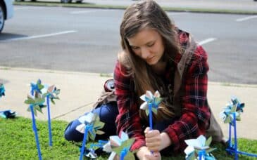 Polk County 4-H member Minnes Smith helps complete the pinwheel garden as part of Child Abuse Prevention Month in front of One Door Polk in Cedartown on Wednesday, April 5.
(Jeremy Stewart)