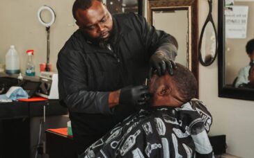 Freddrick B. Cannon, owner of Unique Images Barbershop and Salon in Cuthbert, gives a free shave to a participant of the Haircuts & Hams event.